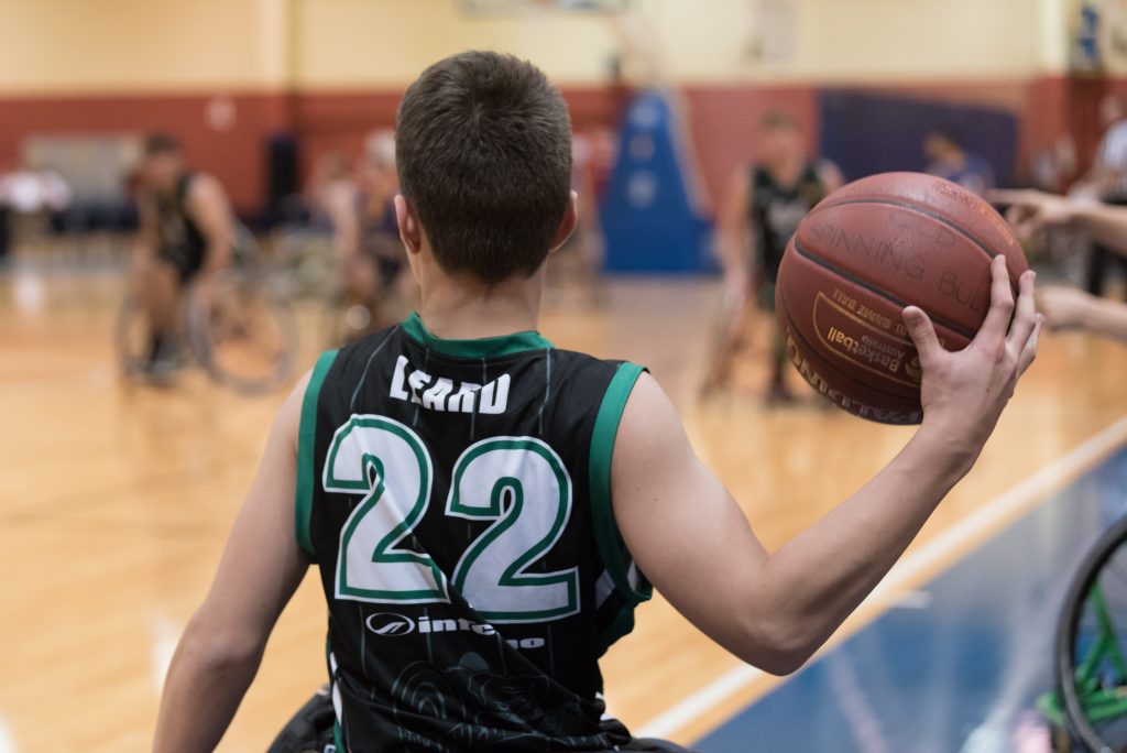 wheelchair basketball player preparing to throw a basketball